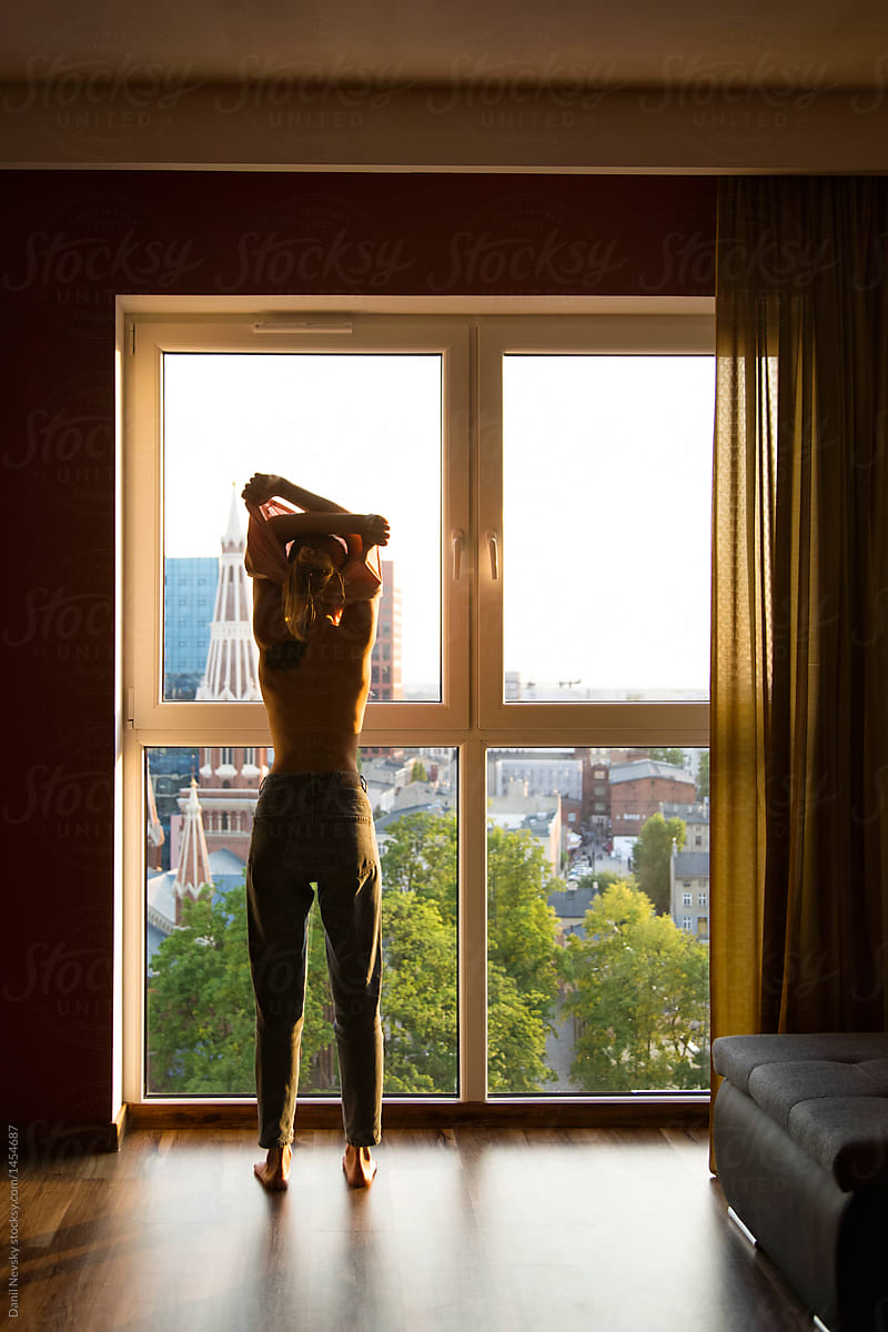 Woman Undressing In Front Of Window By Danil Nevsky