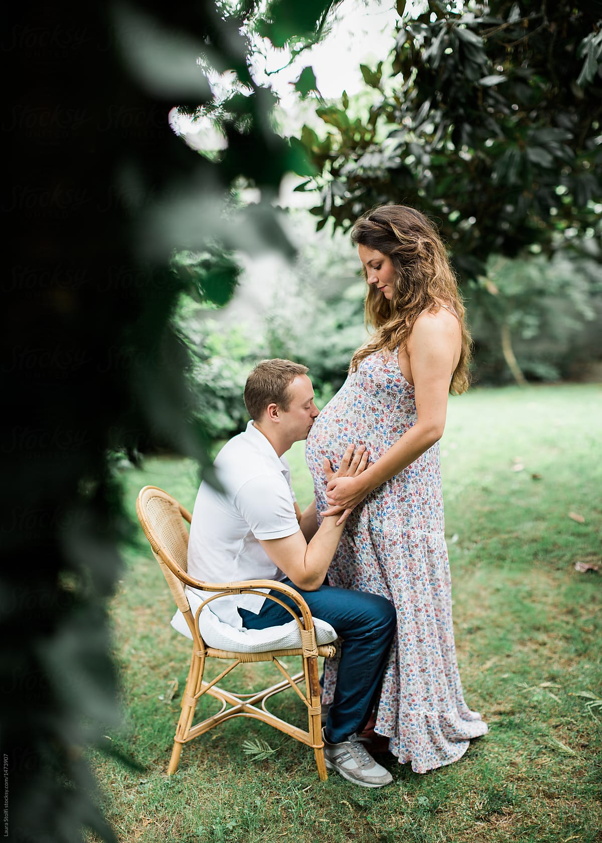 Maternity Session With Man Kissing Wifes Pregnant Belly By Stocksy Contributor Laura Stolfi