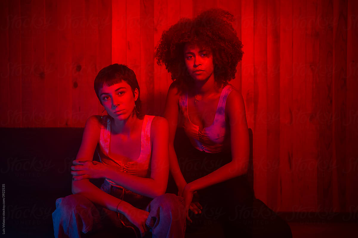 Multiracial Portrait Of Two Girls With Red Lights.