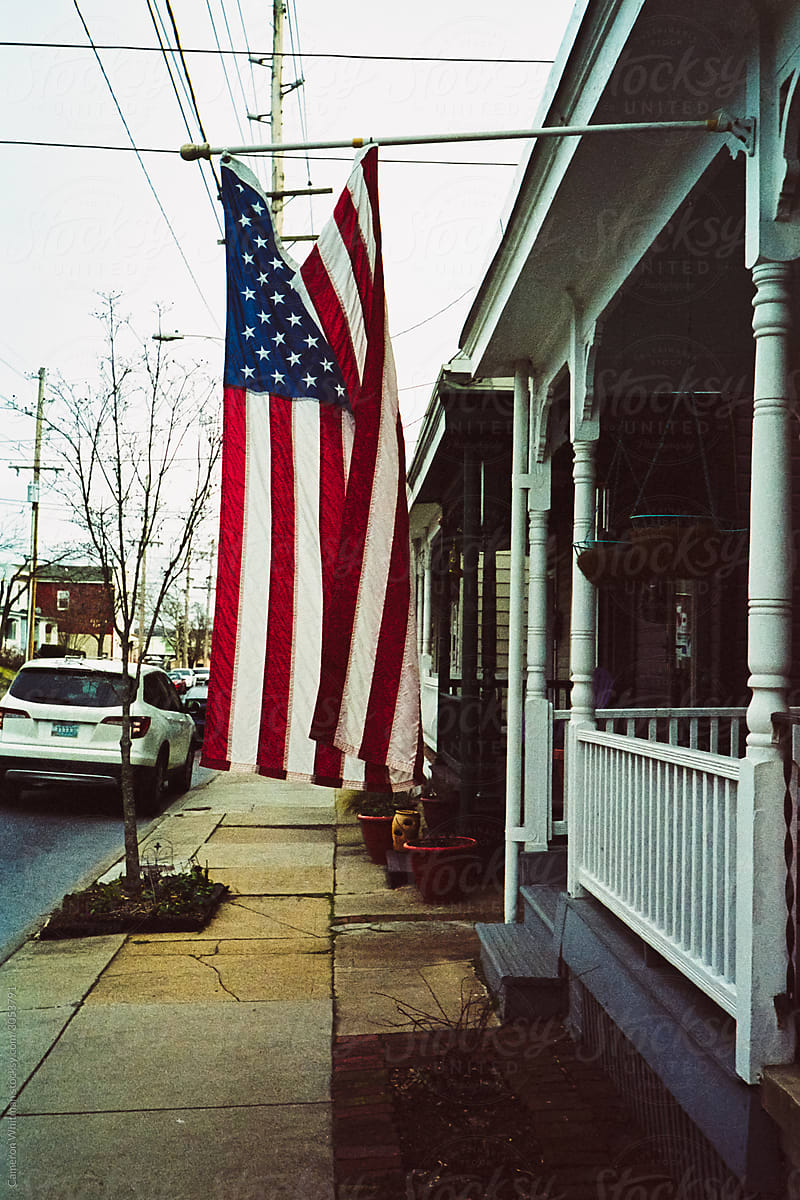 US flag hangs limply from a townhome in Frederick Maryland
