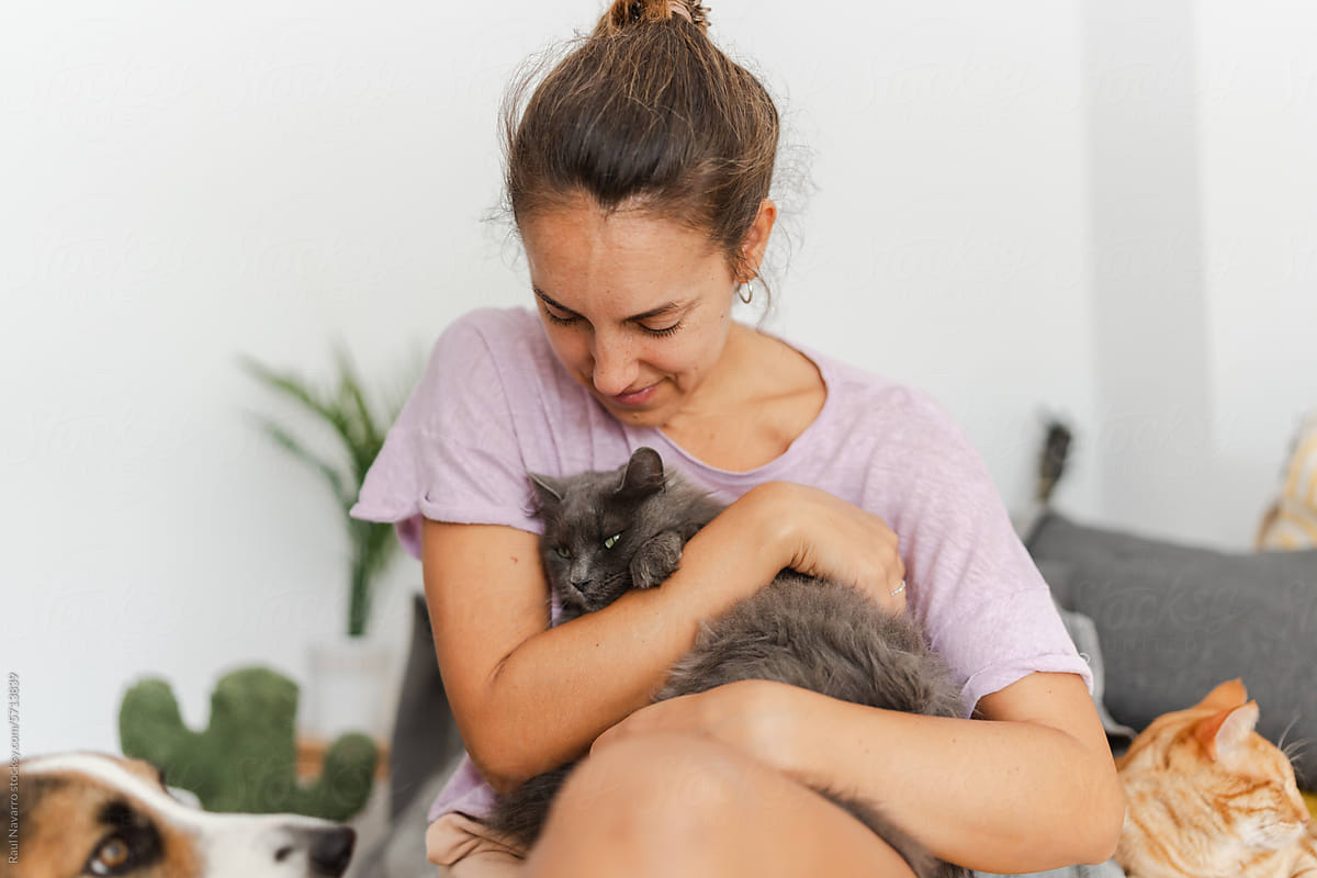 happy woman at home with her pets