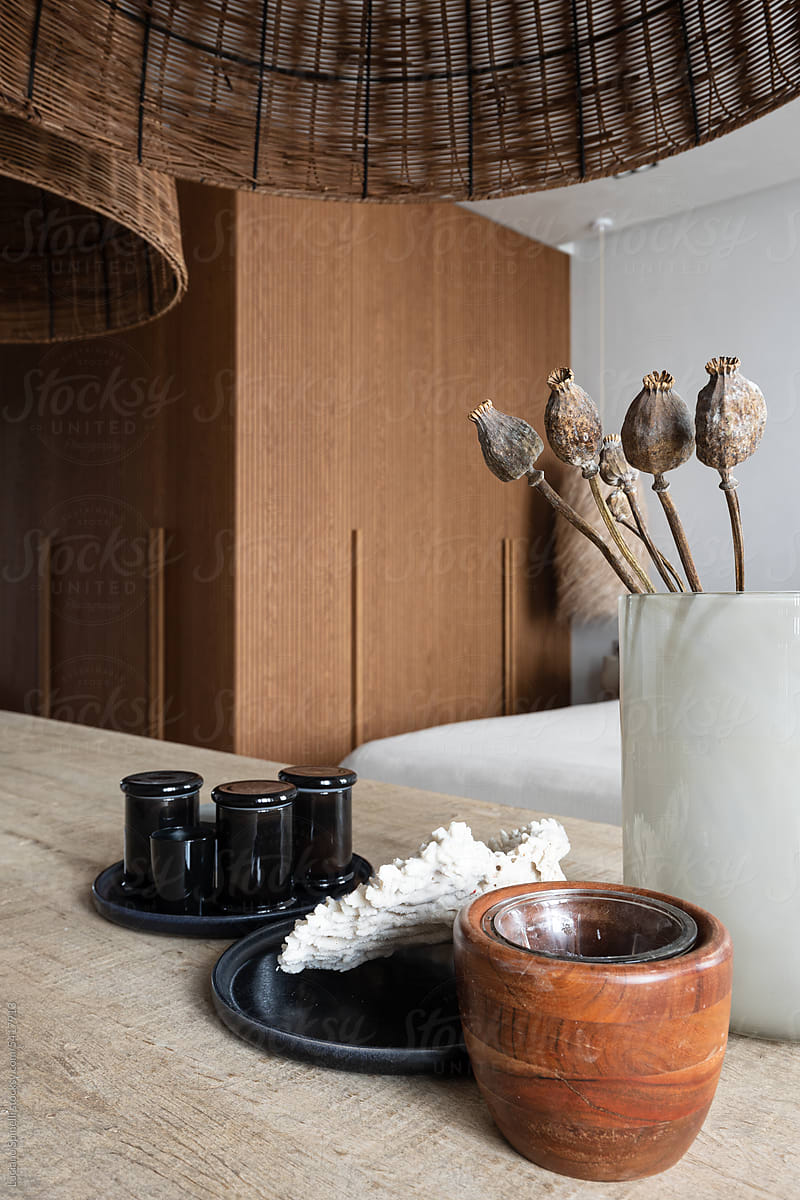 Wood table in cozy natural home, with candle, dry flower, shell, pot