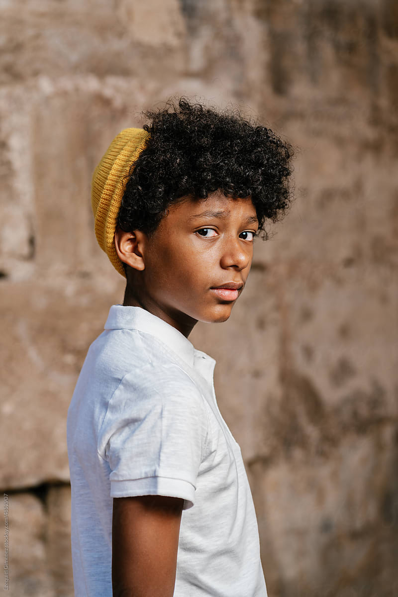 Black boy in polo shirt and hat