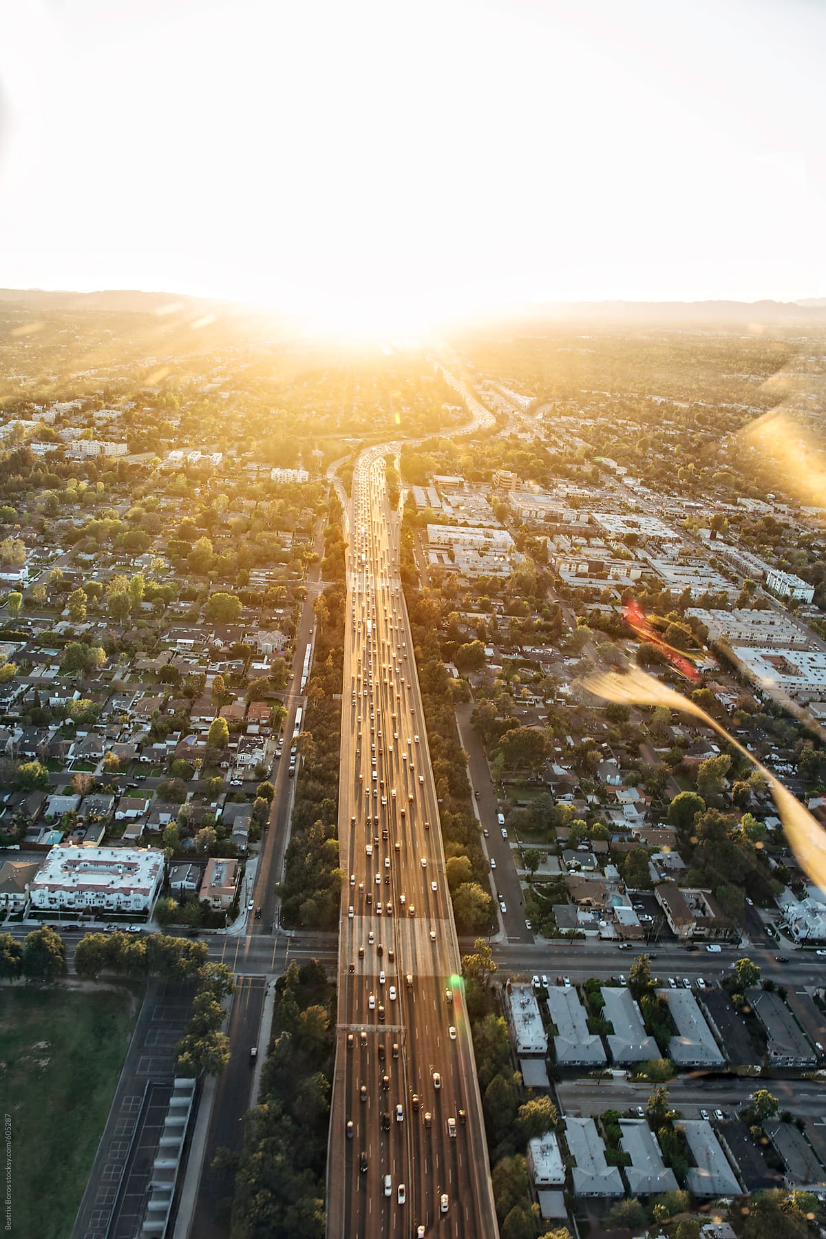 Freeway with a lot of traffic illuminated by the Sunset