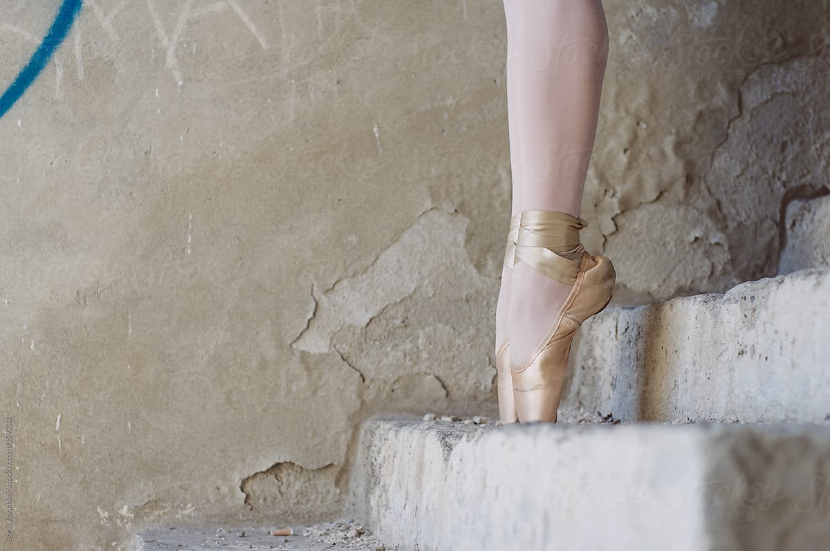 Ballerinas legs on old stairs