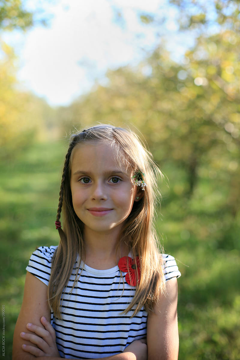 A Pretty Girl With Flowers In Her Hair In A Sunny Autumn Apple Orchard 