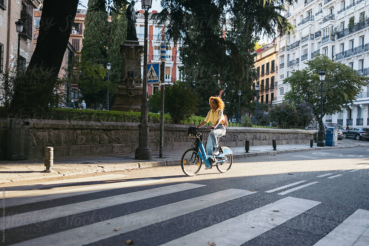 Woman riding a rental electric bike in the city