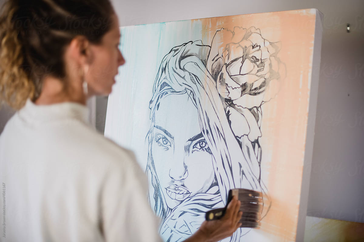 Woman paints a female portrait.