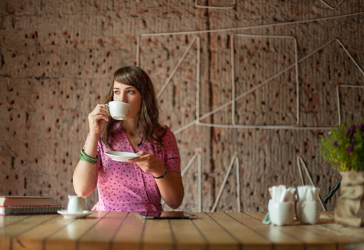Woman Drinking Coffee In A Coffee Shop Del Colaborador De Stocksy Mosuno Stocksy
