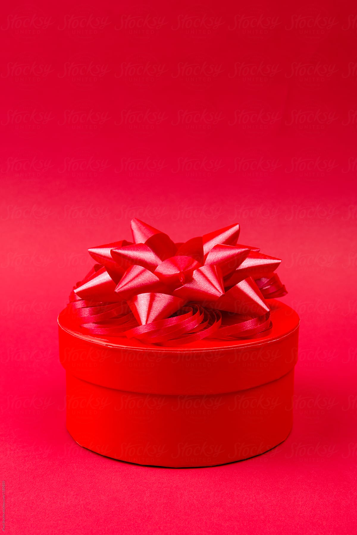 Red gift on red background