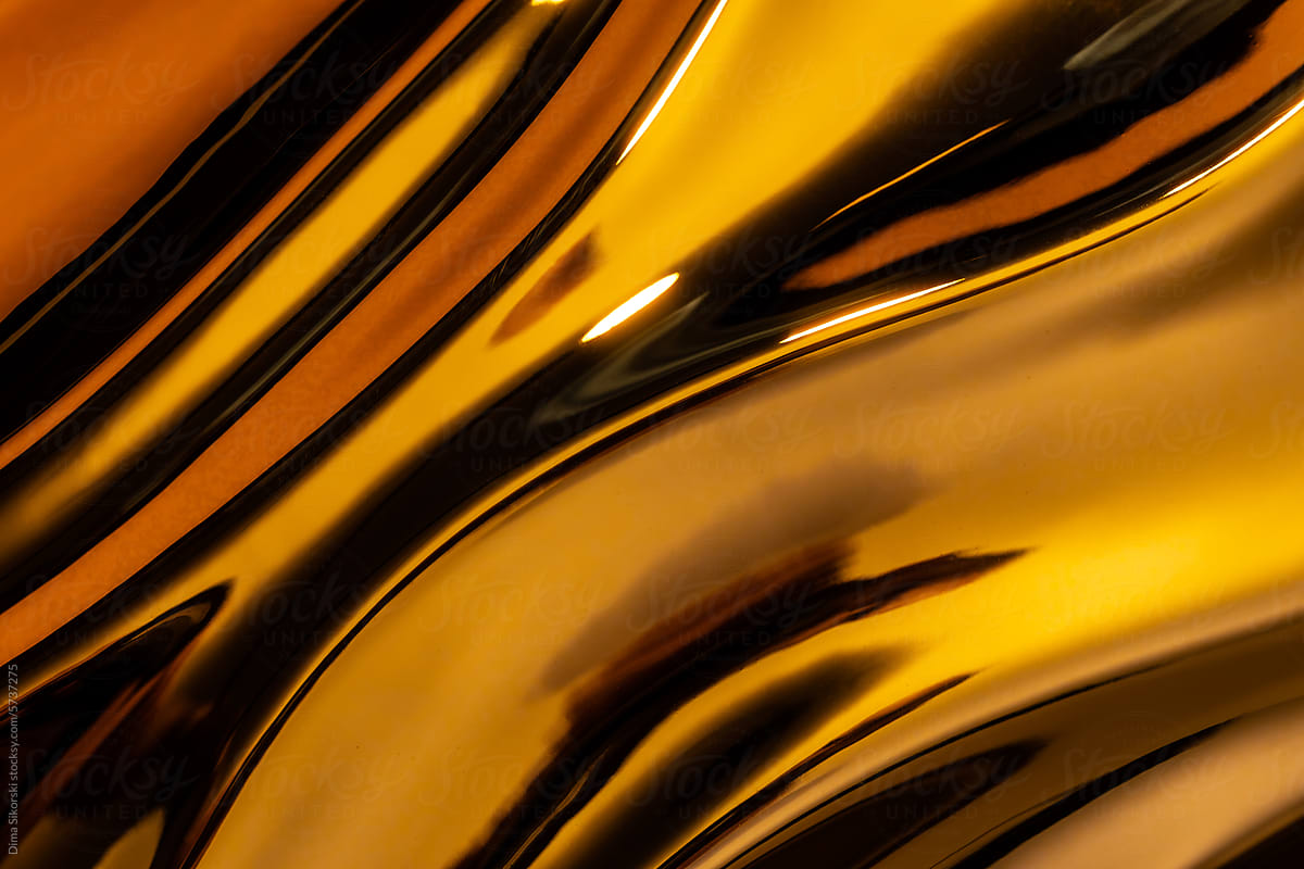 Abstraction with three-dimensional golden waves of metallic texture