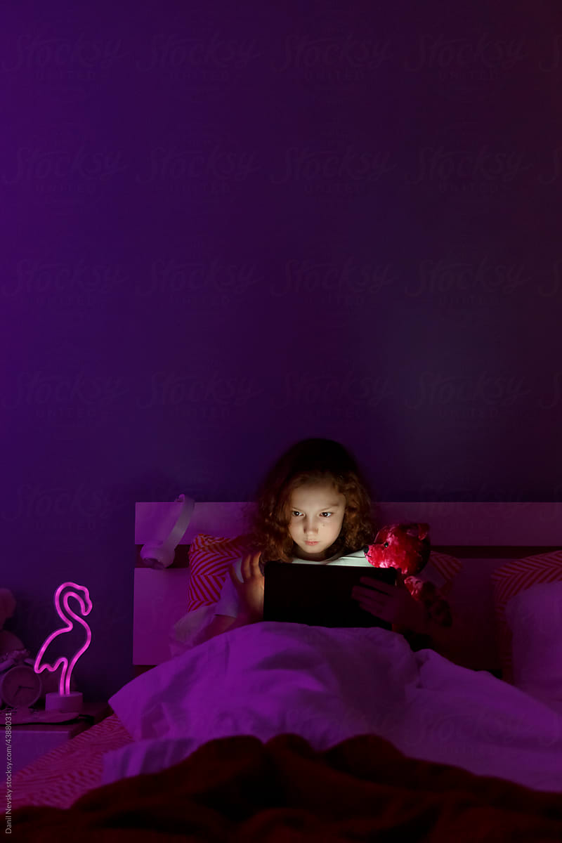 Girl scrolling social media at night