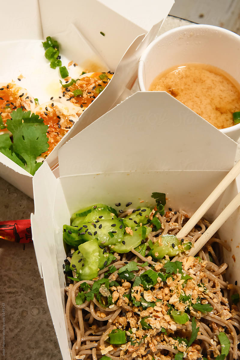 Soba noodle salad dish from food truck cart in to-go packaging.