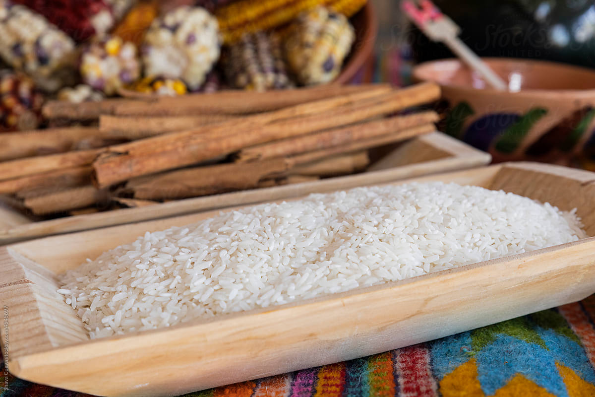 White rice grains in grains inside a wooden container