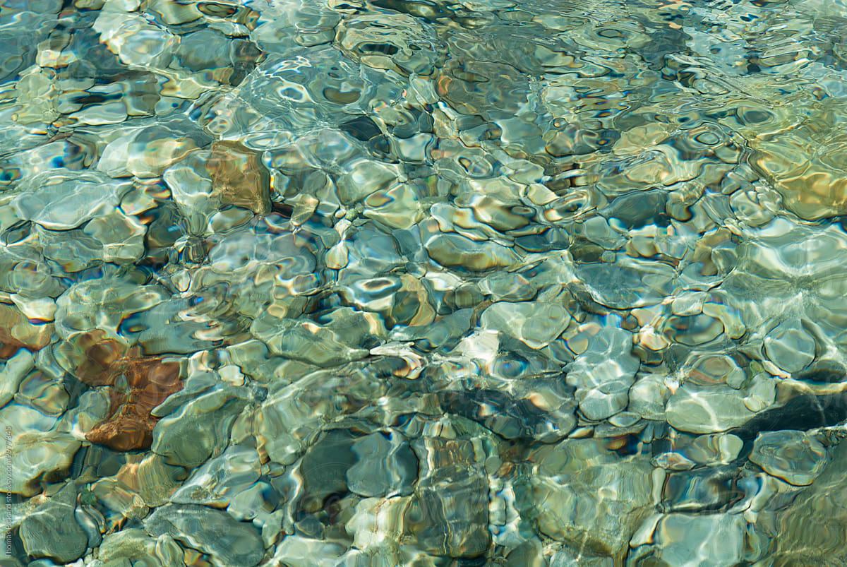Abstract view of pebbles and water, New Zealand.
