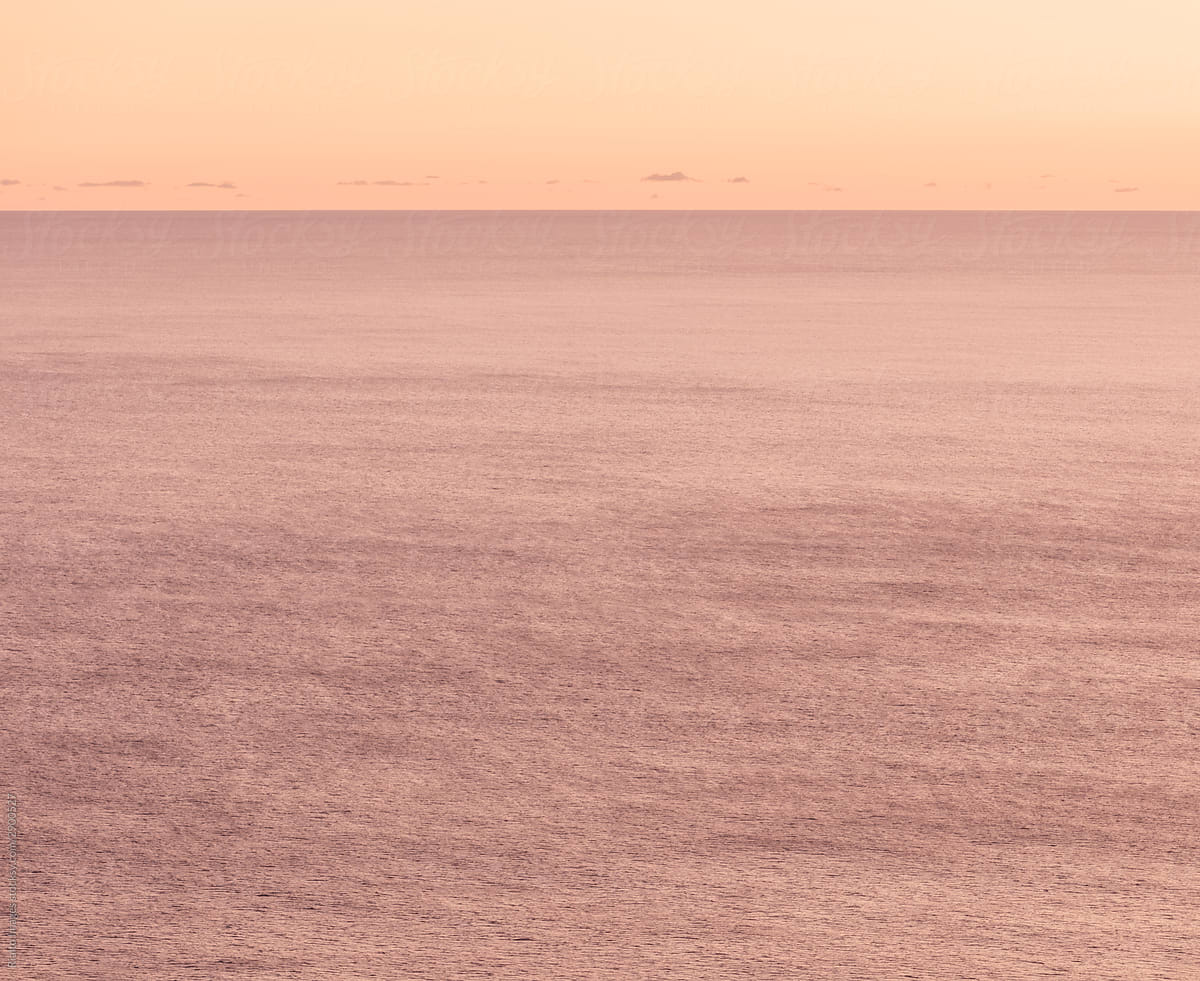Expansive view of vast ocean, horizon and sky at dawn