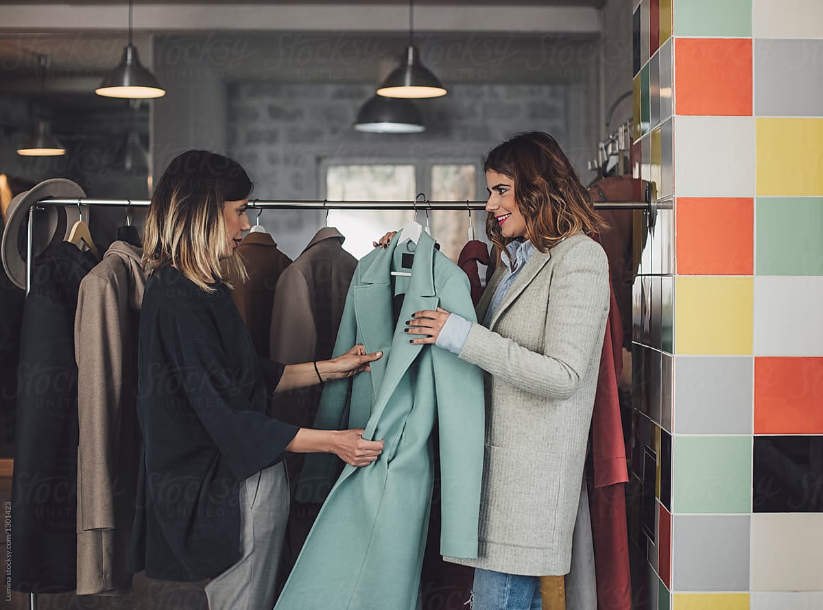 Women Choosing Coat at Showroom