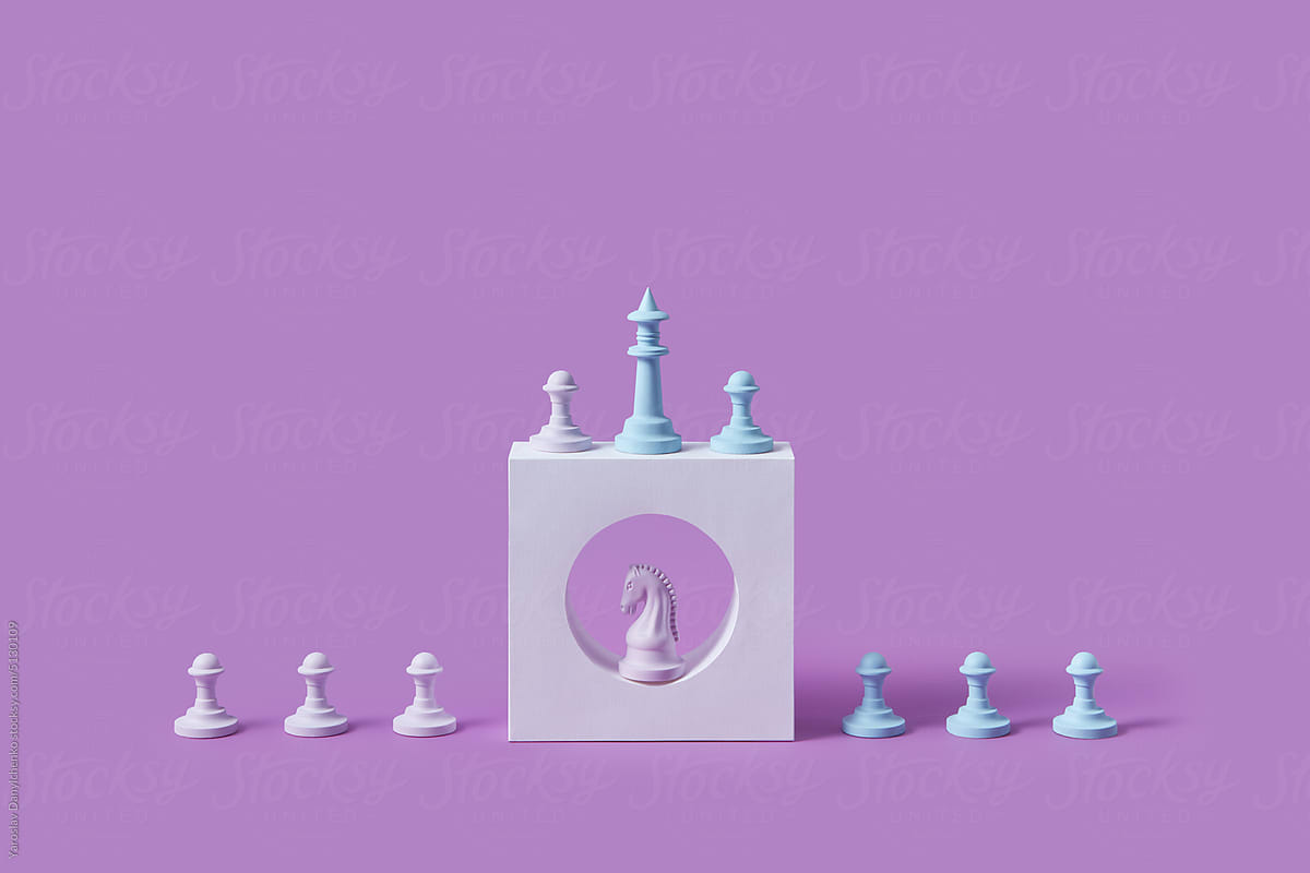 Chess pieces on white stone shape.