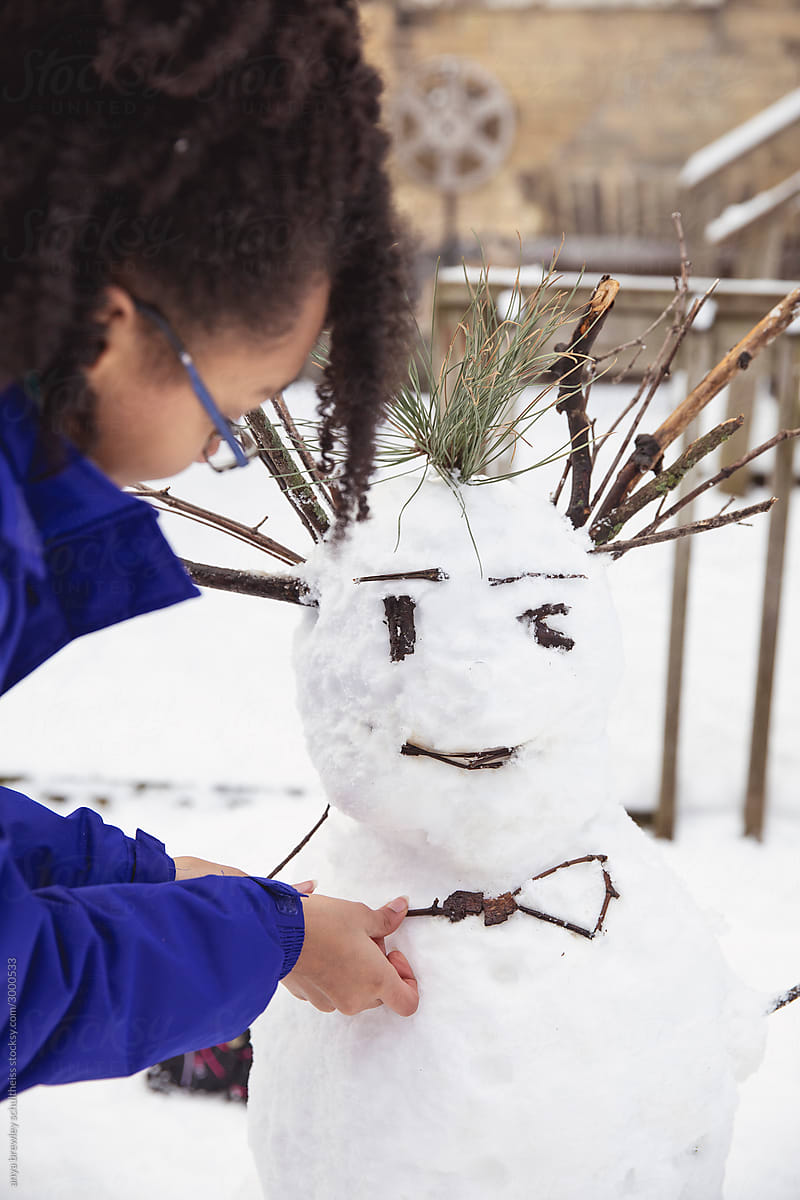 Closeup of teenager building a snowman