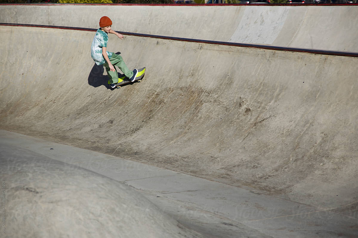Young skater riding on concrete ramp