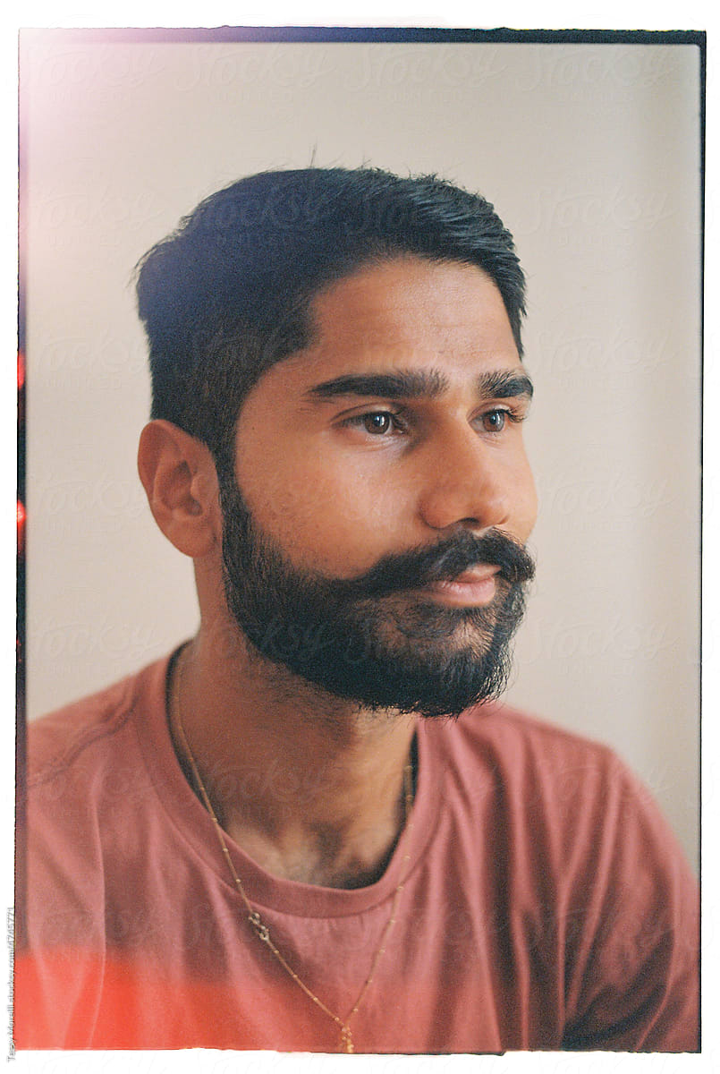 Film portrait of Indian young man meditative