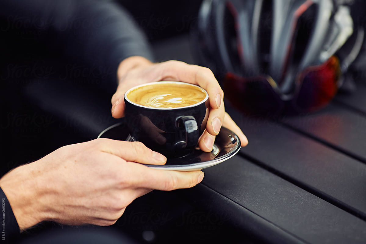 Male Road Cyclist stops for coffee mid ride