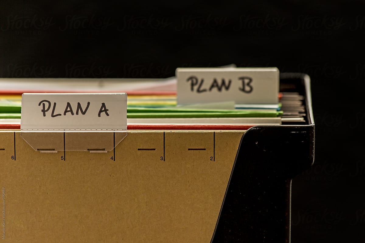 Closeup of plastic file holder with files labeled Plan A and Plan B
