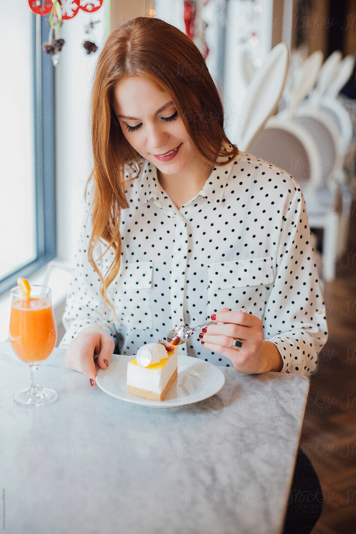 Woman Eating her Dessert and Drinking Orange Juice