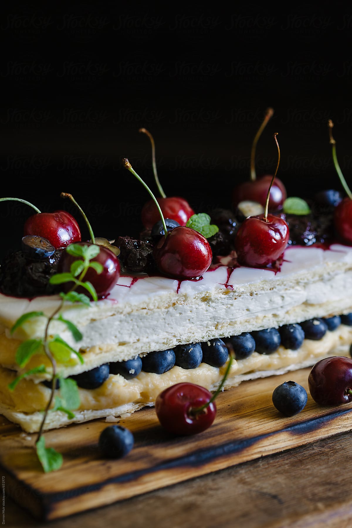 The layers of a mille-feuille, with creme pat, chantilly cream and fruits.
