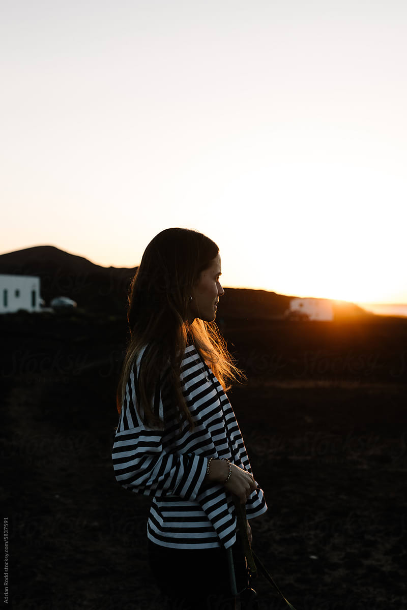 Portrait of a young woman watching the sunset