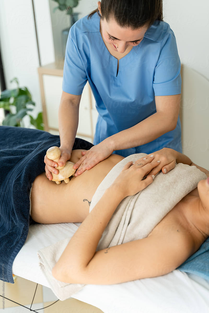 Woman in the spa receiving a reductive massage on the abdomen..