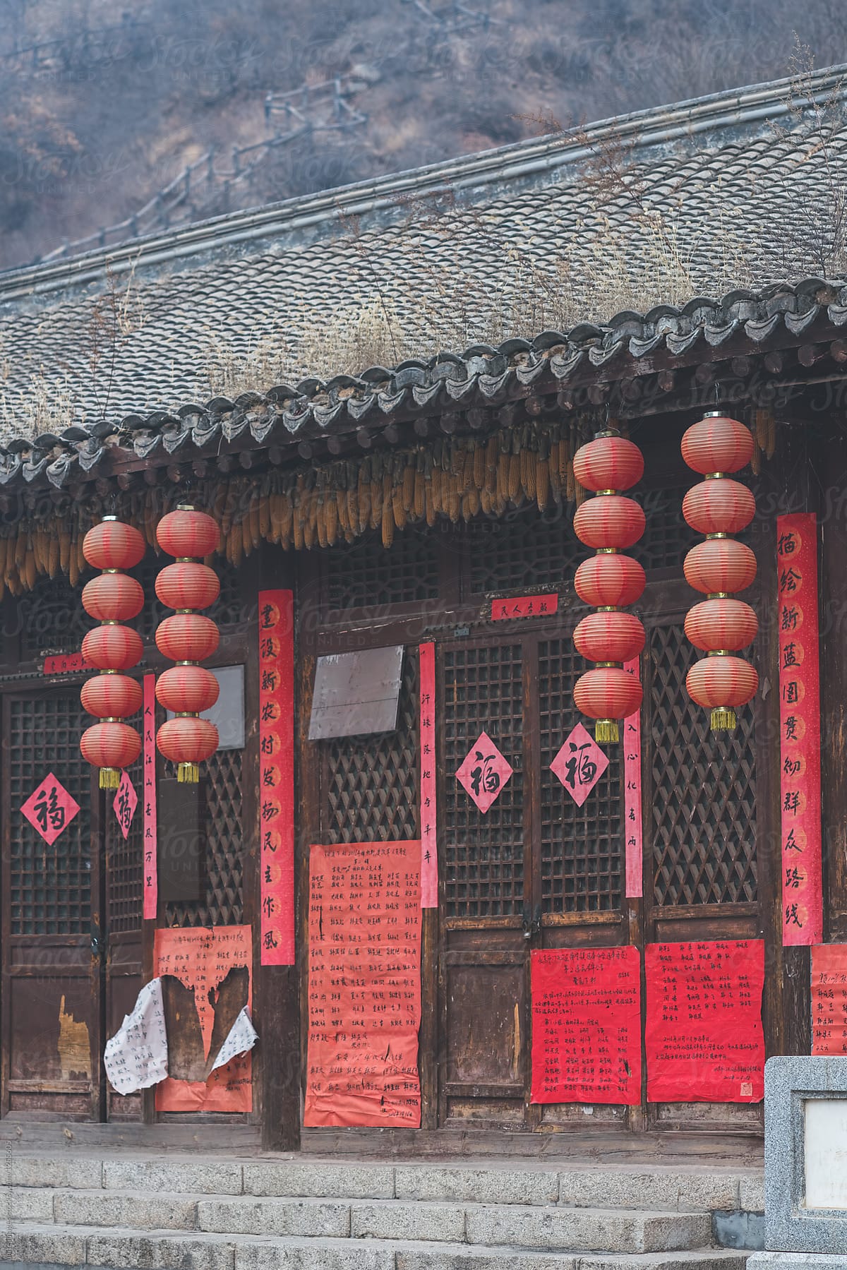 traditional residential house door with red lanterns hanging on eaves
