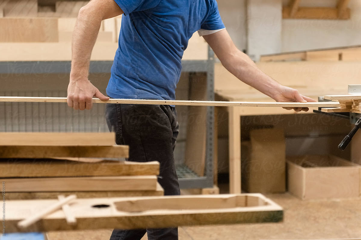 Carpenter in workshop cutting wood