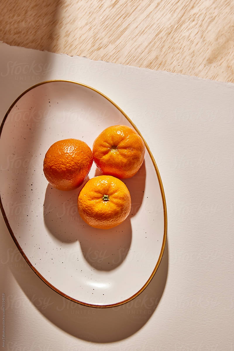 Multiple clementines on a plate