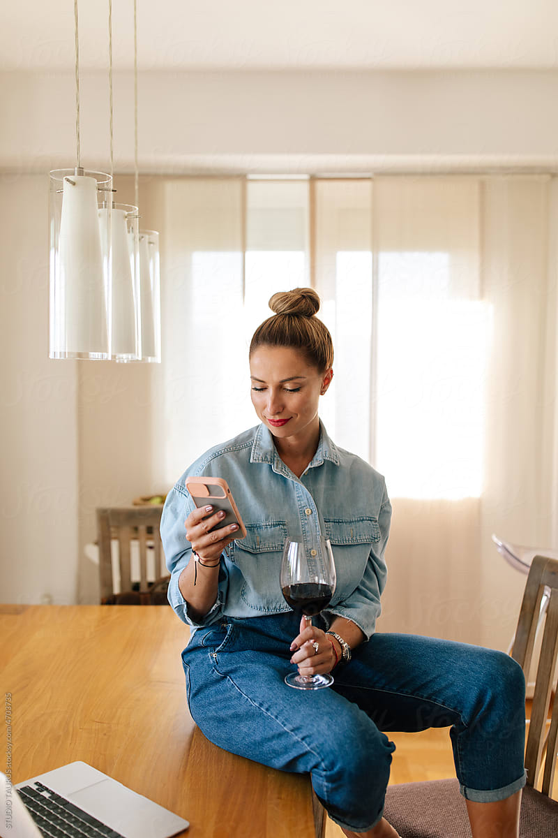 Woman On The Phone While Drinking Wine