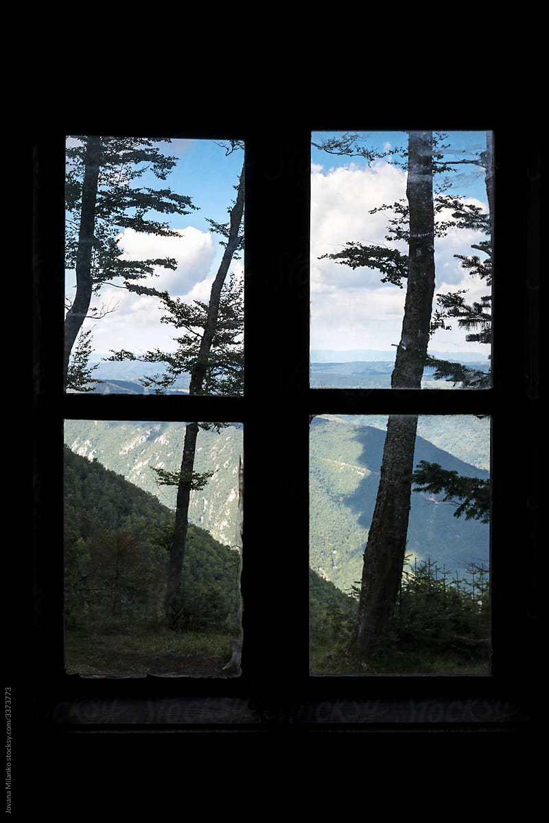 Closed window overlooking mountains
