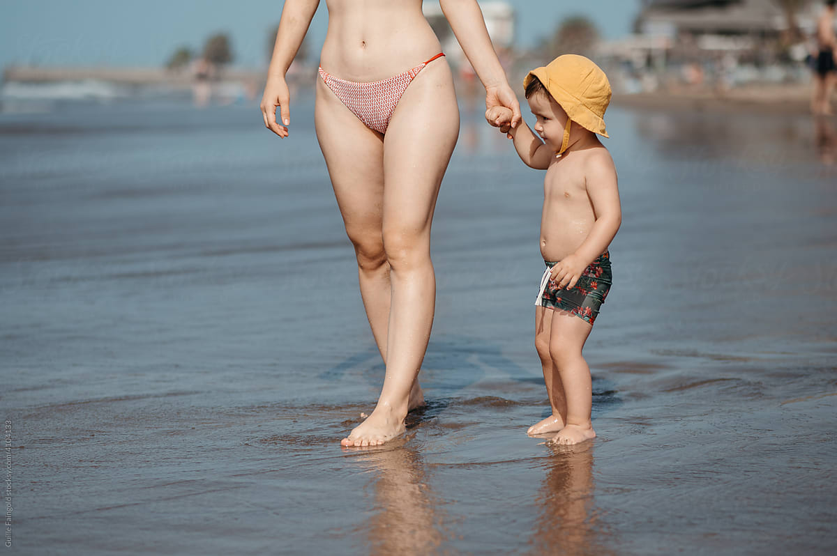 Toddler with mother on coast.