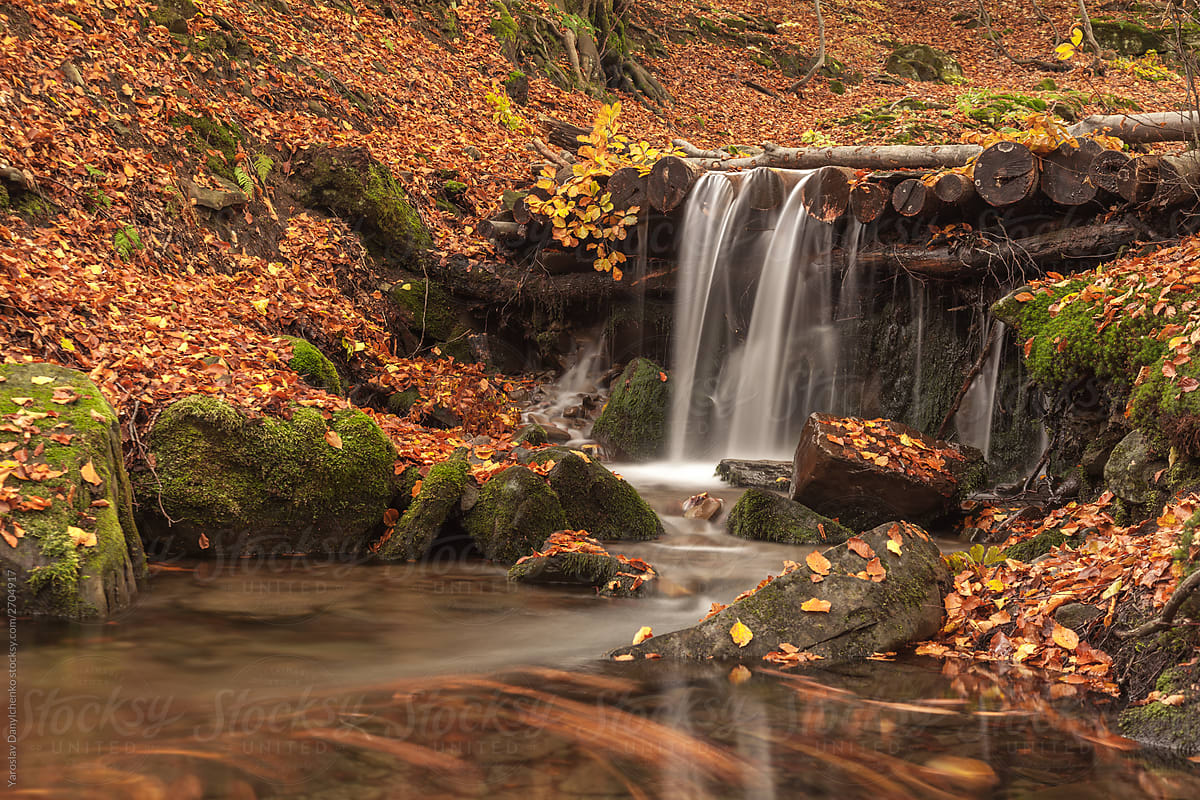 Mountain waterfall in the autumn forest.