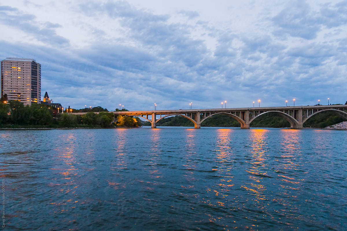 Evening cityscape of river and bridge