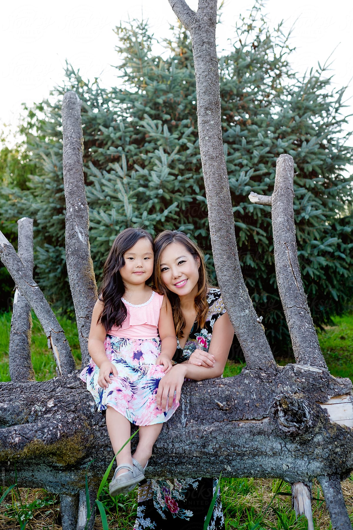 Happy Asian mother and daughter in a park