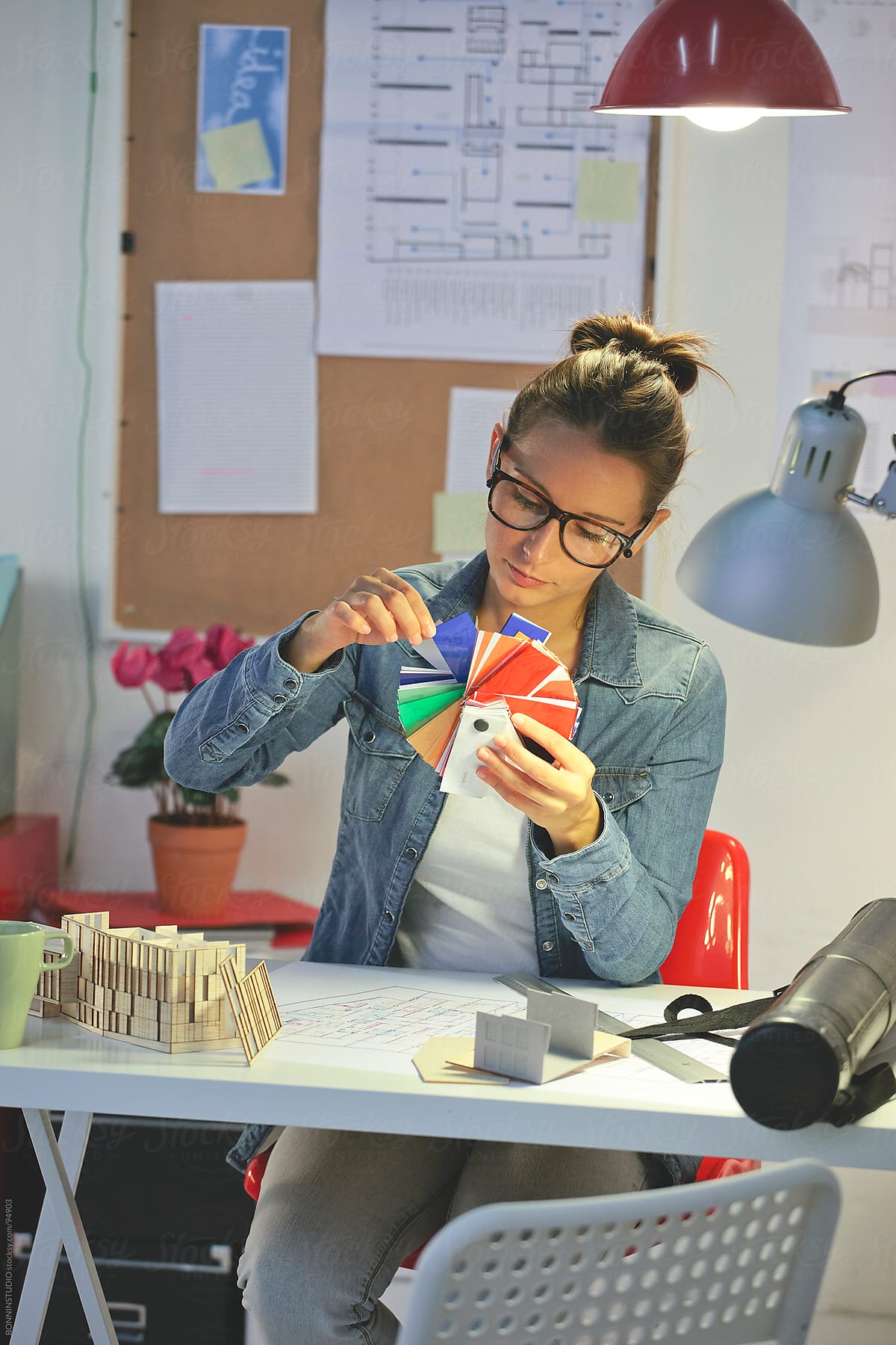 Young architect woman selecting colours in her office.
