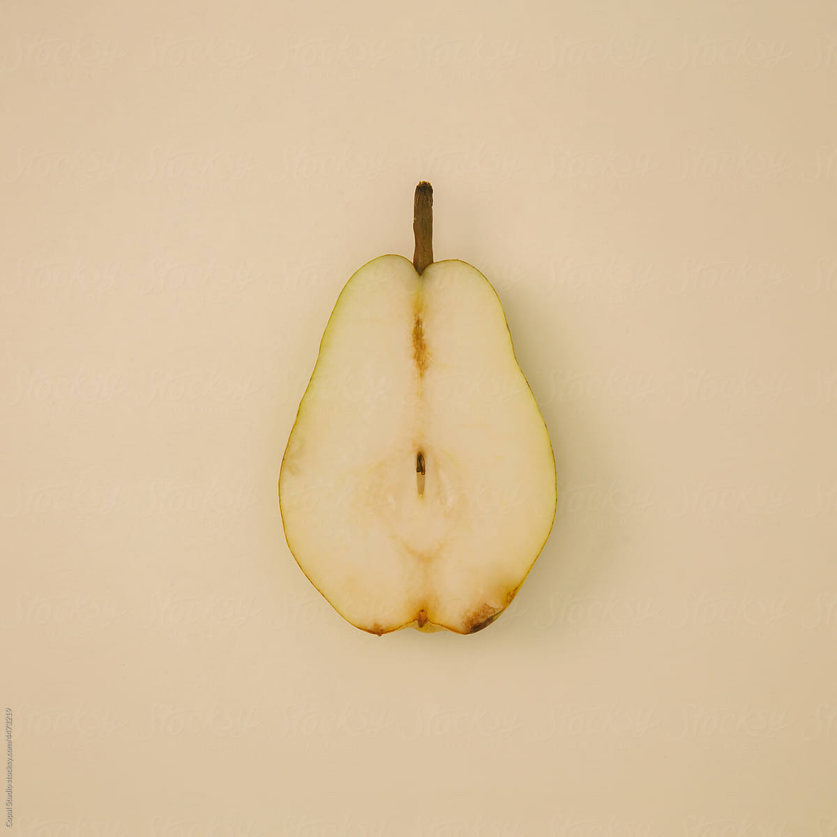 Sliced Pear on tan backdrop
