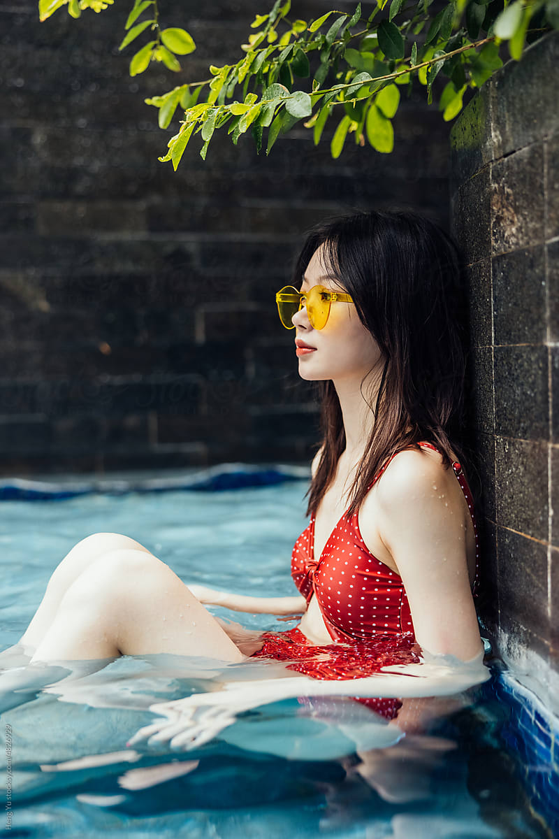 Female model sitting in pool