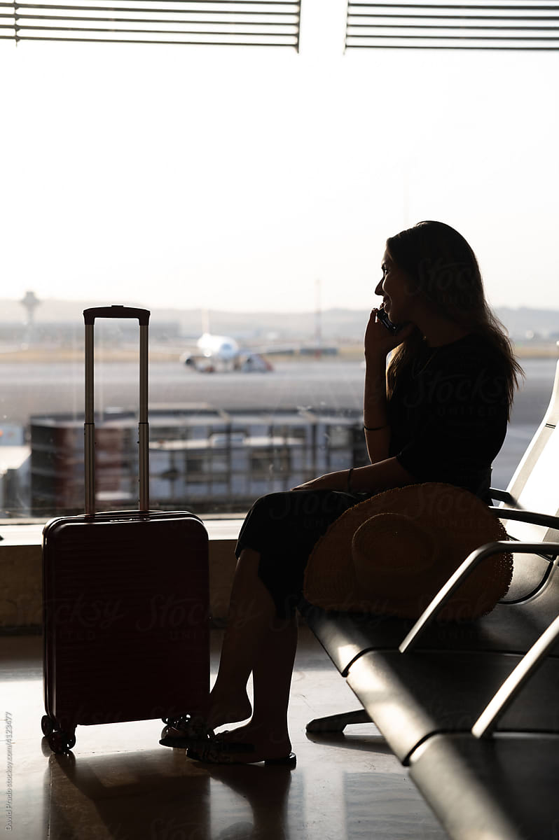Traveler browsing smartphone at airport