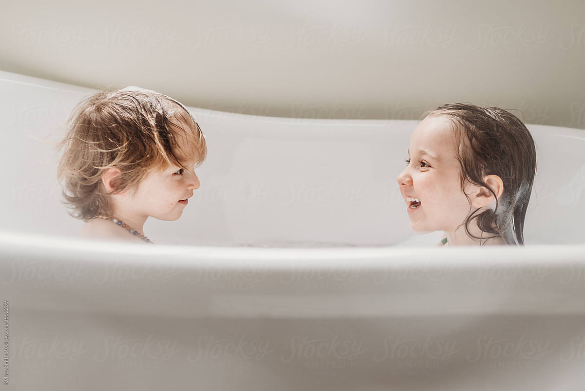 Siblings enjoying bath time