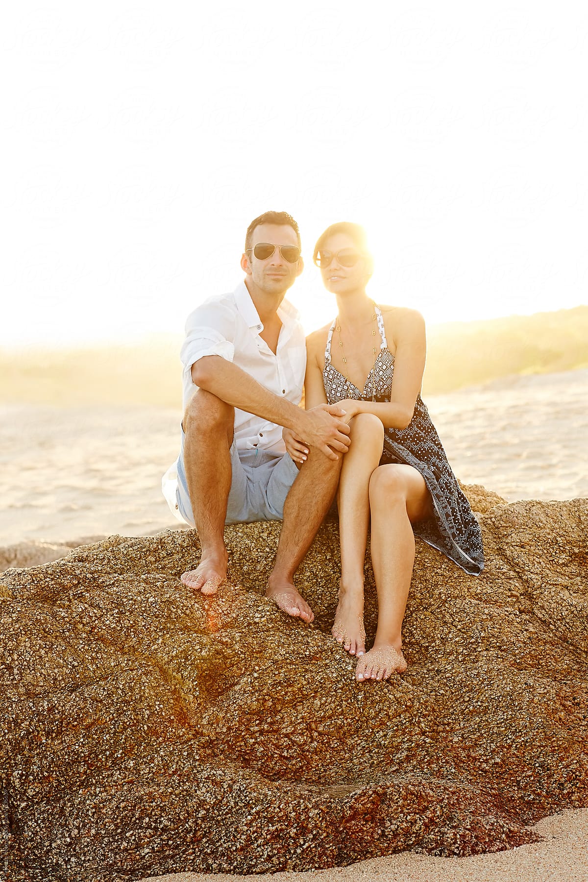 Couple Sitting On Rock At Beach At Sunset On Vacation In Mexico By Stocksy Contributor 4204