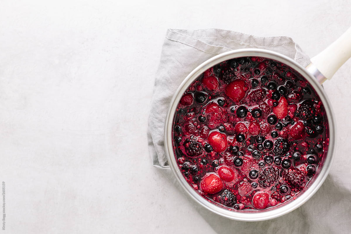 Summer fruits and berries in saucepan