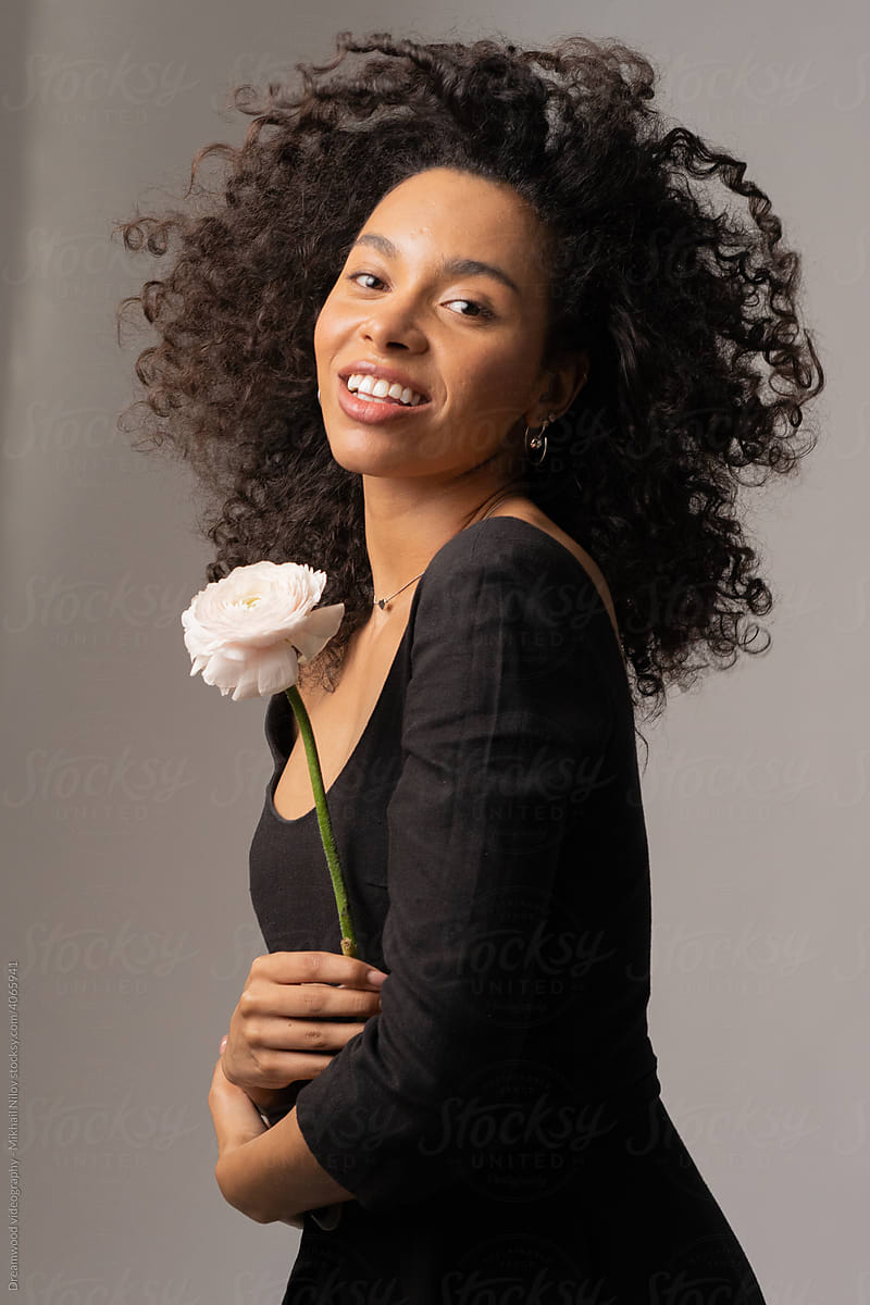Beautiful woman holding a pink flower