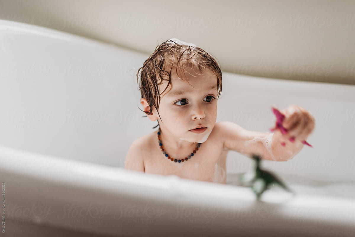 Toddler In Bubble Bath by Stocksy Contributor Kelsey Smith