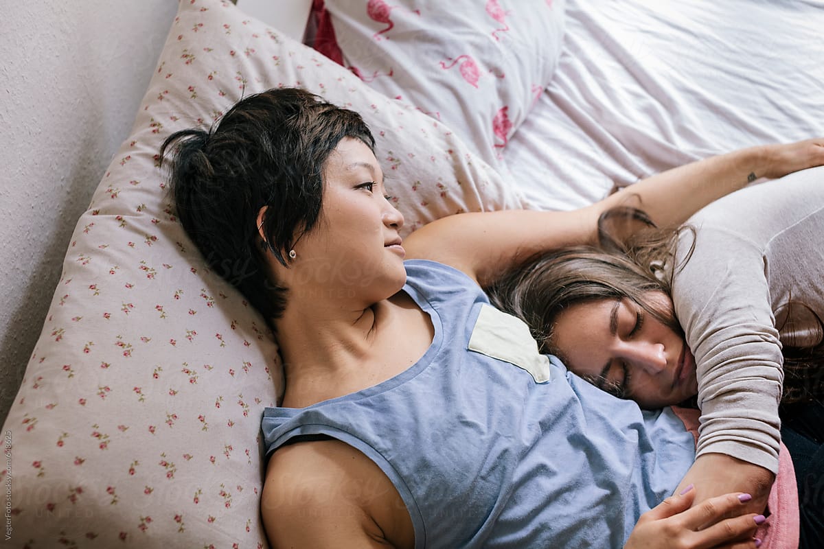 Lesbian Couple Relaxing In Bed/